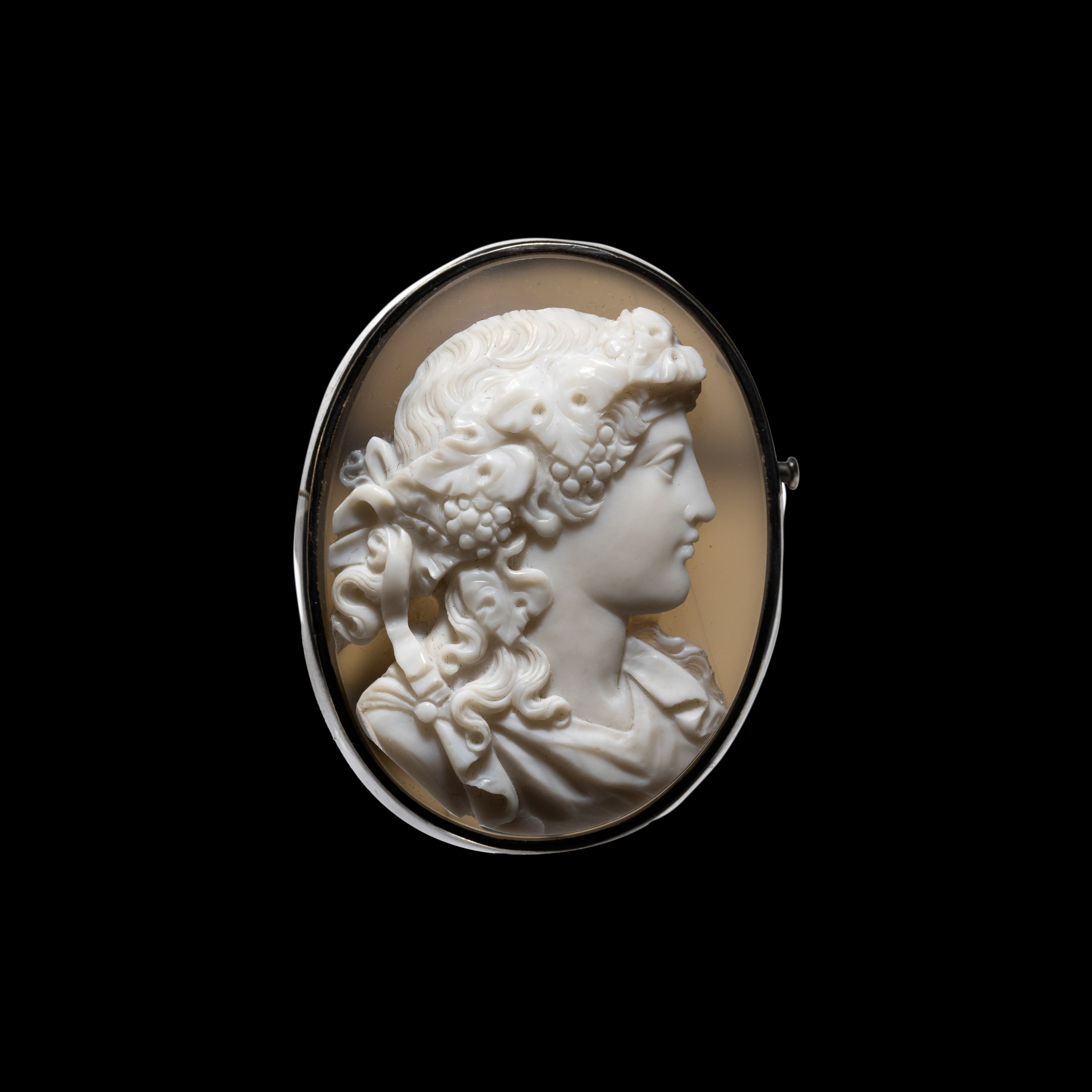 A silver brooch set with a large Neoclassical agate cameo. Bust of Maenad. 
